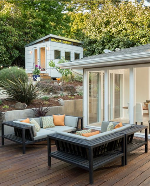 A cozy backyard showcasing a patio adorned with comfortable furniture, perfect for enjoying the outdoors.
